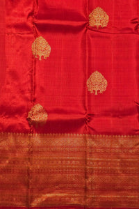 Red fabric with gold tree patterns