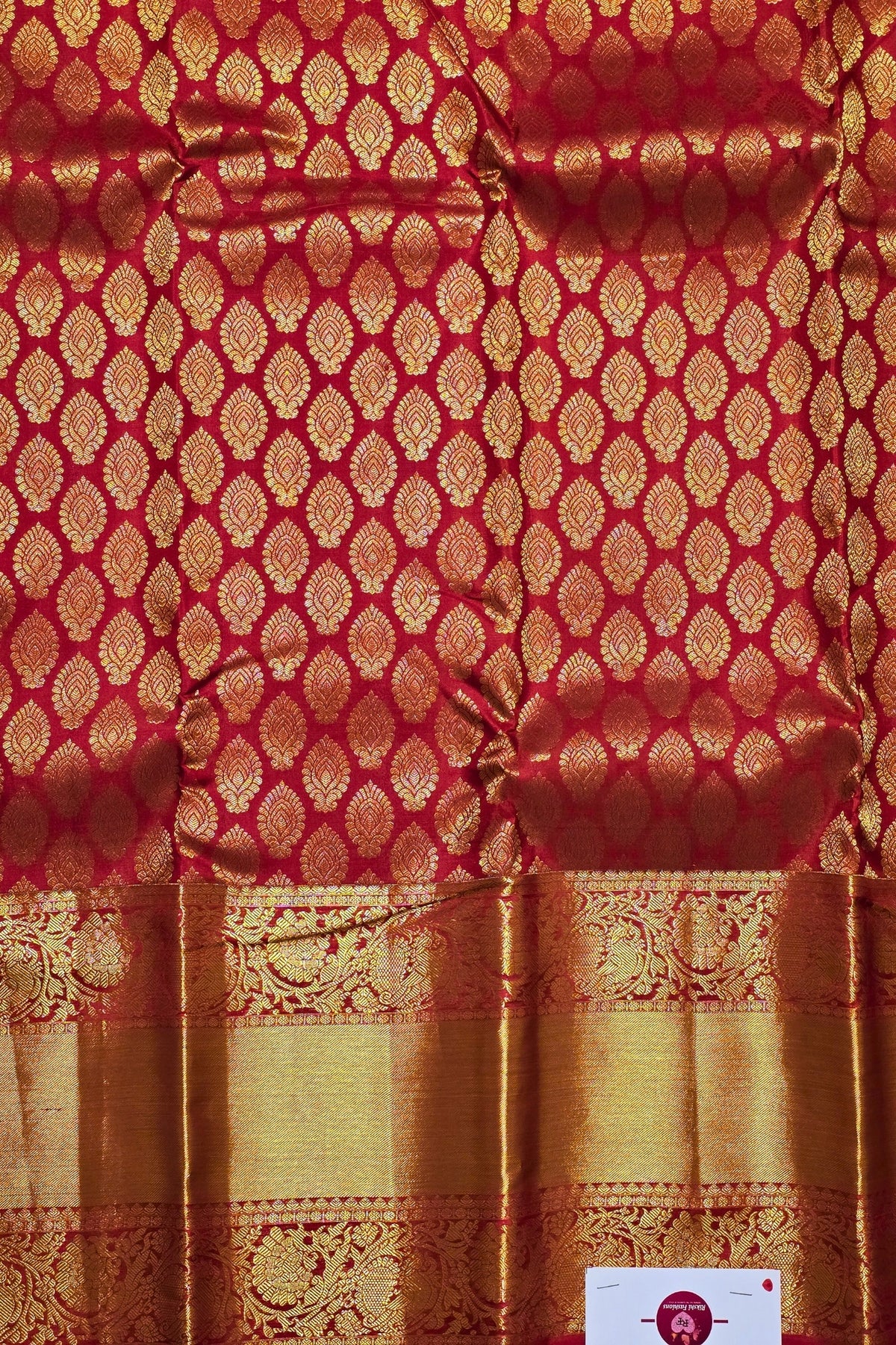 Red fabric with gold pattern and border