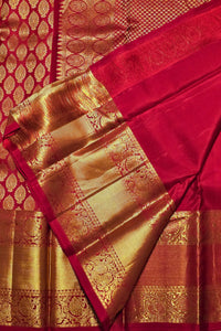 Red and gold traditional fabric with intricate patterns