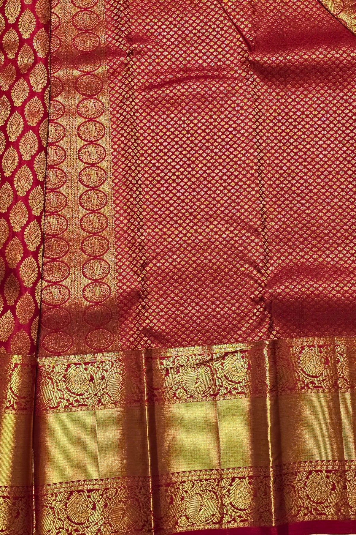Red and gold traditional fabric with intricate patterns