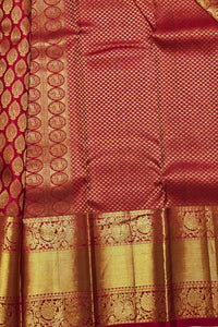 Red and gold traditional fabric with intricate patterns