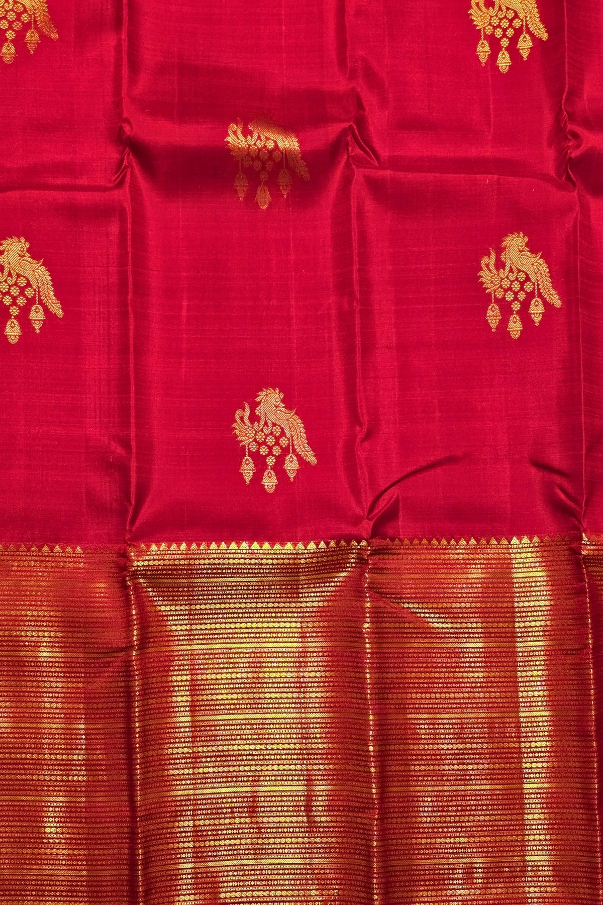 Red fabric with gold patterns and border