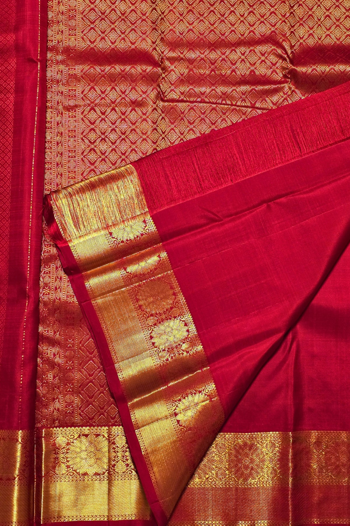 Red saree with gold border and patterns