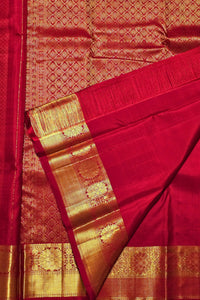 Red saree with gold border and patterns