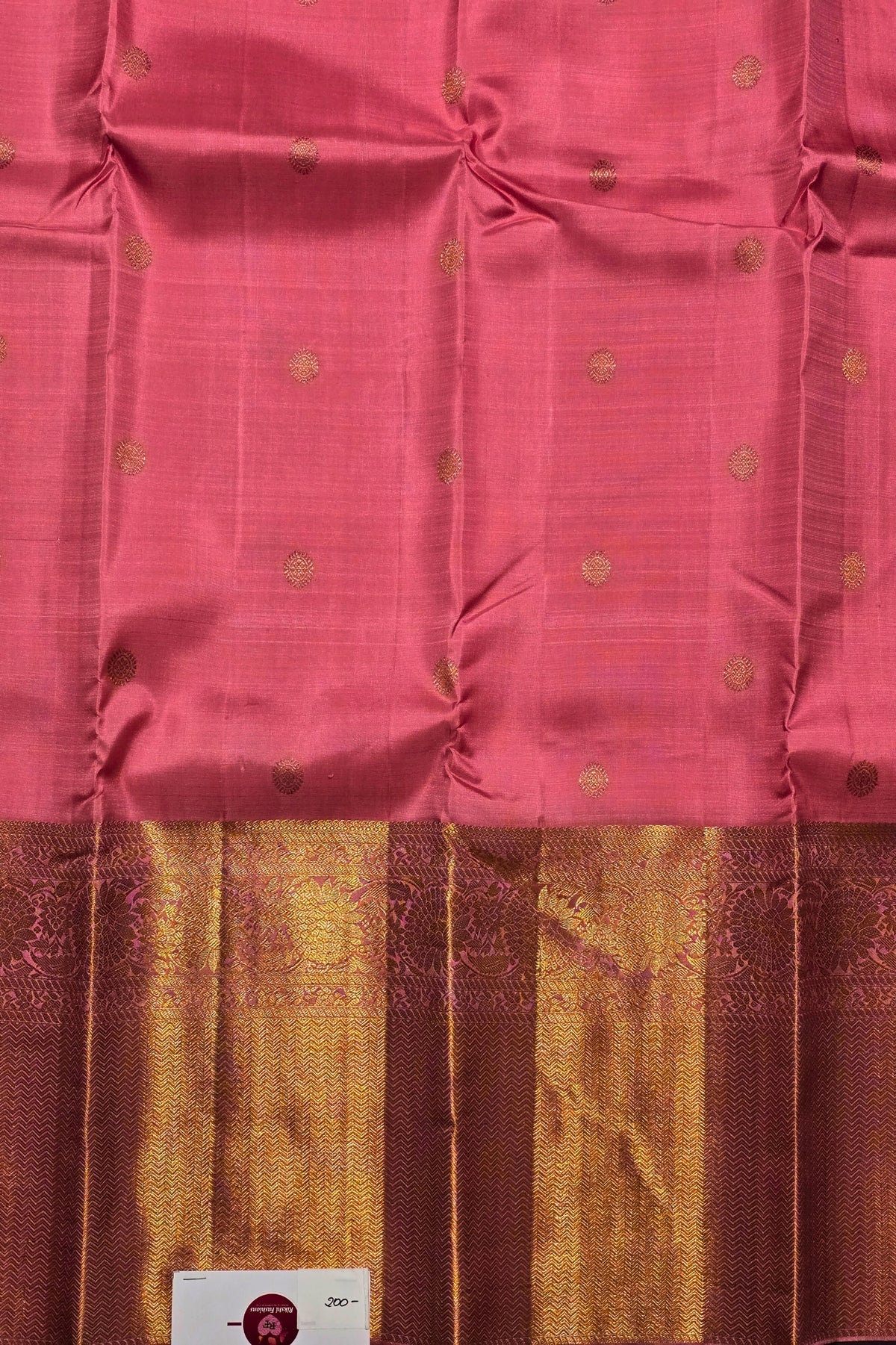 Pink saree with gold border and patterns