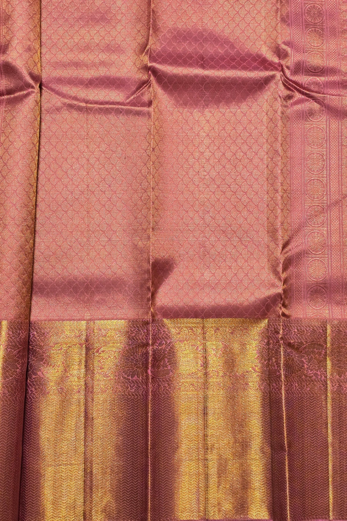Close-up of a pink fabric with a gold border
