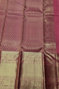 Close-up of a patterned fabric with a maroon and green color scheme.