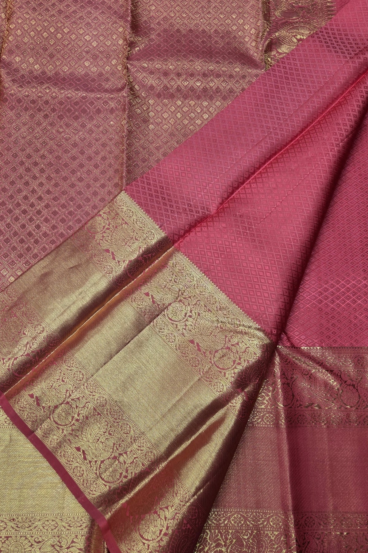 Close-up of a maroon and green saree with intricate patterns