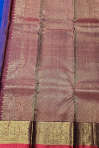 Close-up of a maroon saree with gold border and patterns