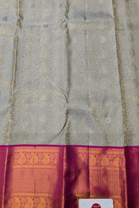 Gray saree with a pink and gold border