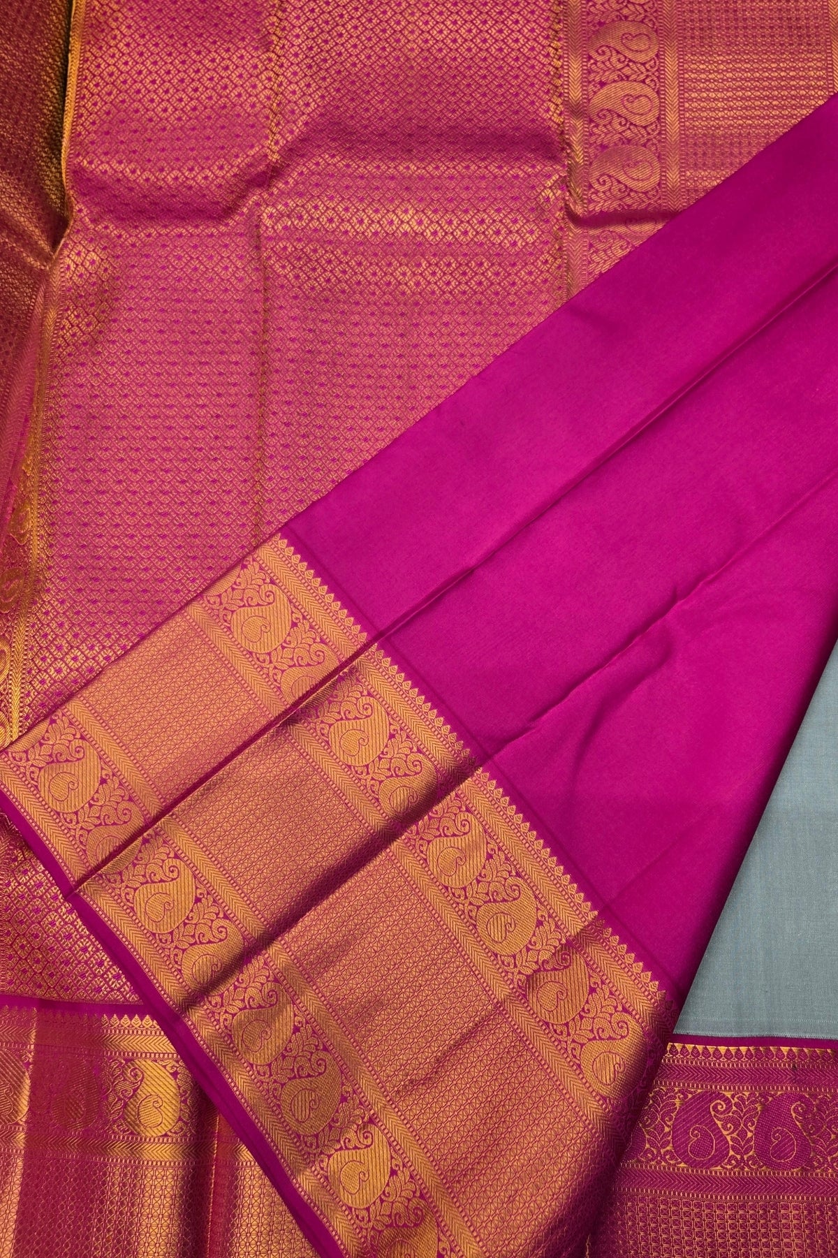 Pink saree with gold border on a plain background