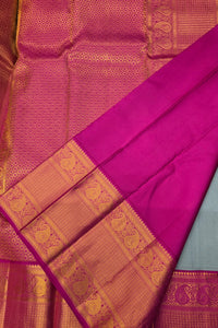 Pink saree with gold border on a plain background