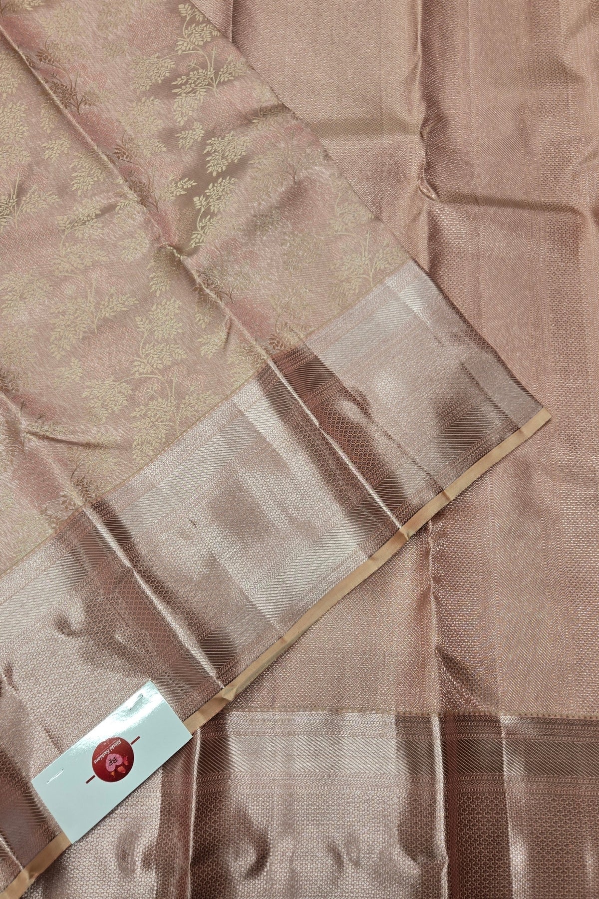 Brown fabric with a subtle pattern and a visible brand label.