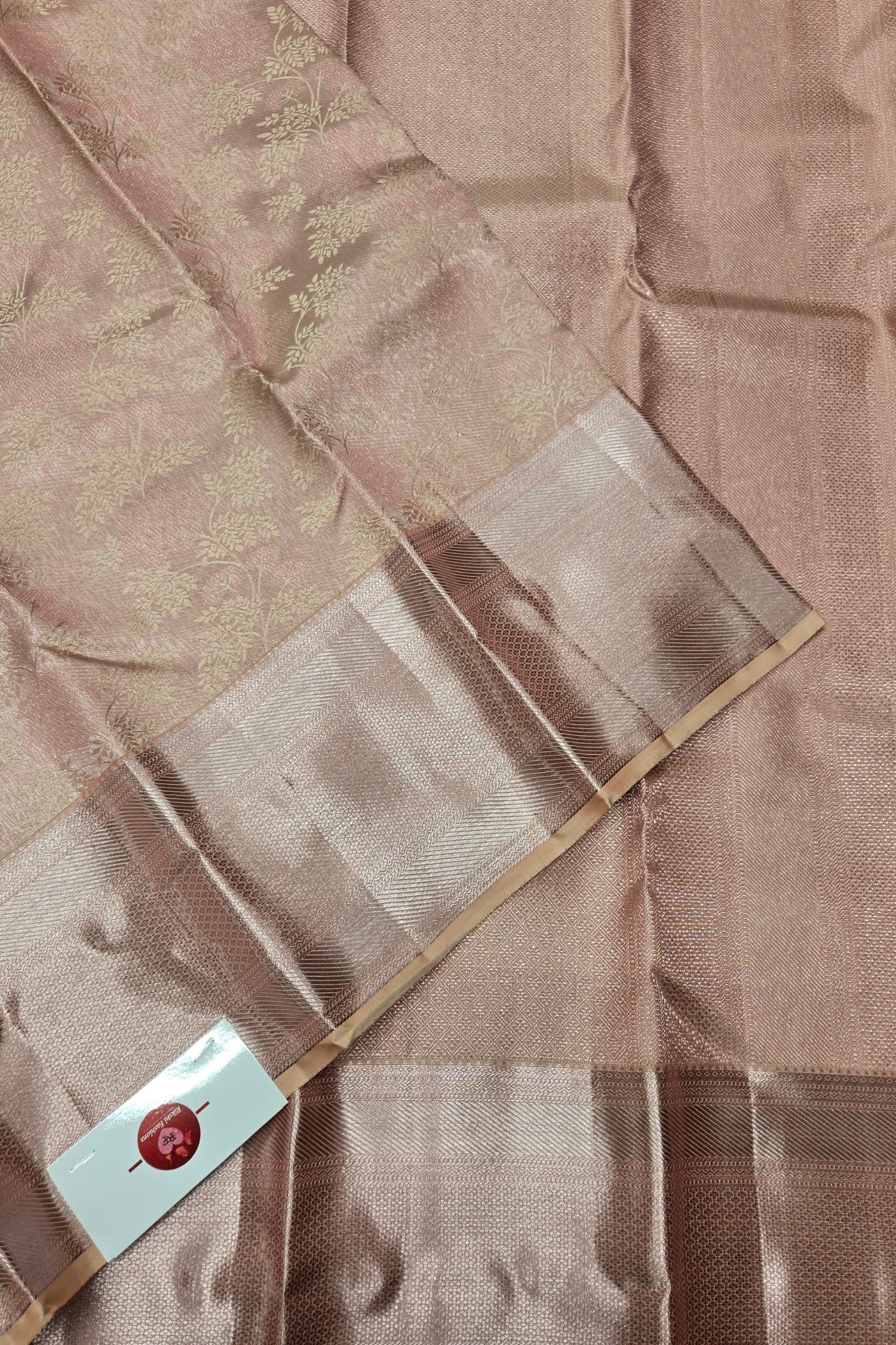 Brown fabric with a subtle pattern and a visible brand label.