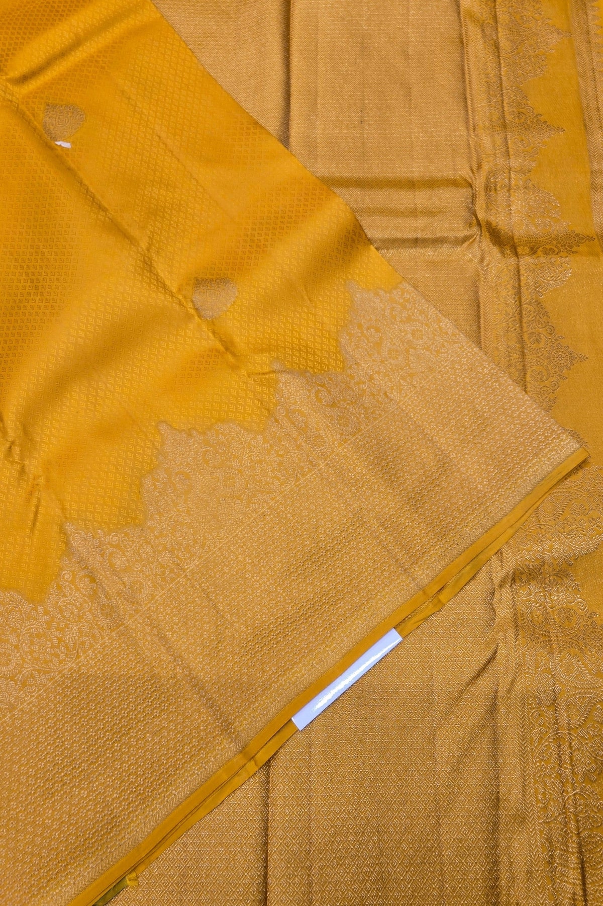 Close-up of a yellow fabric with intricate patterns