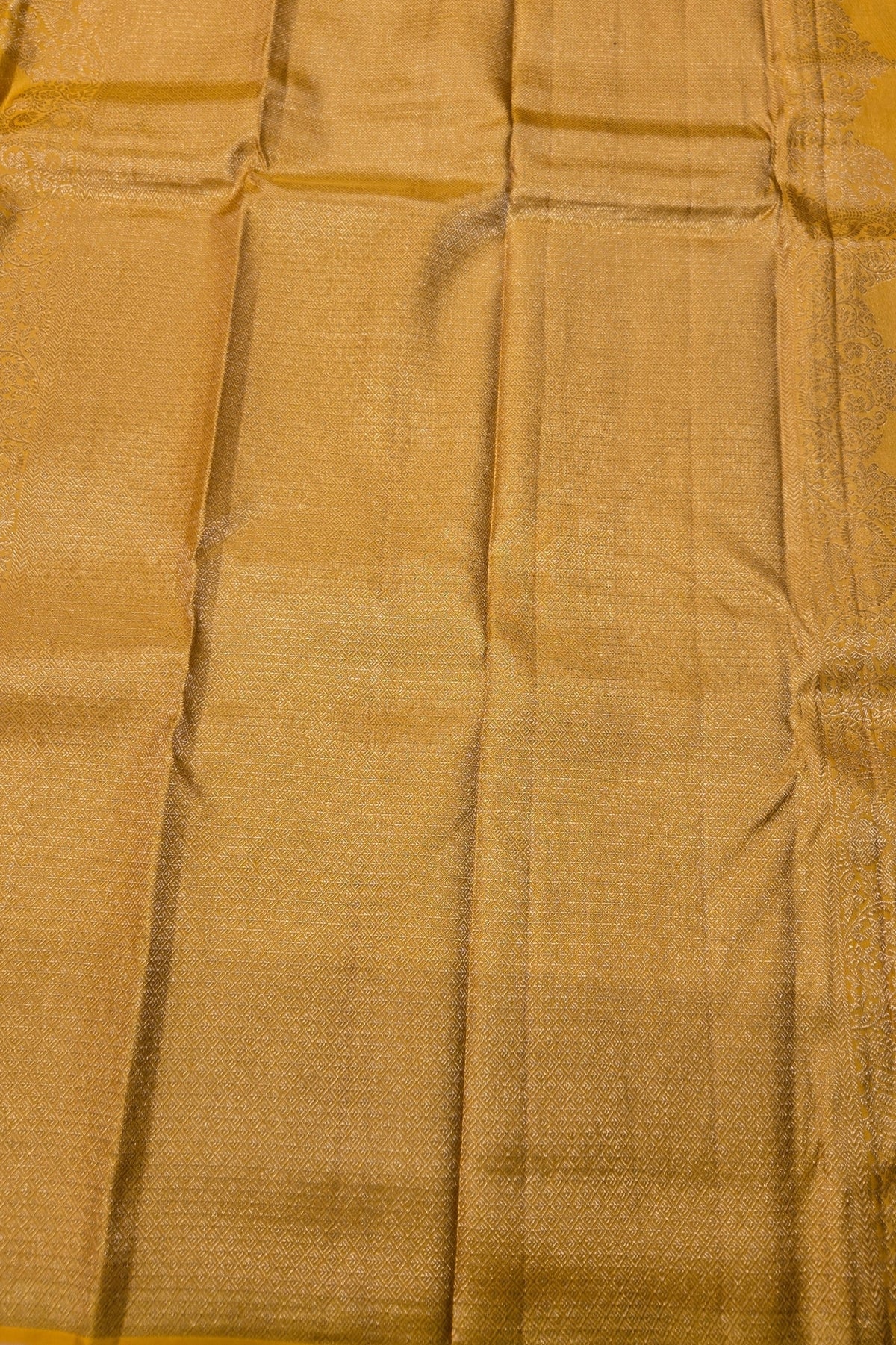 Close-up of gold fabric with a subtle pattern
