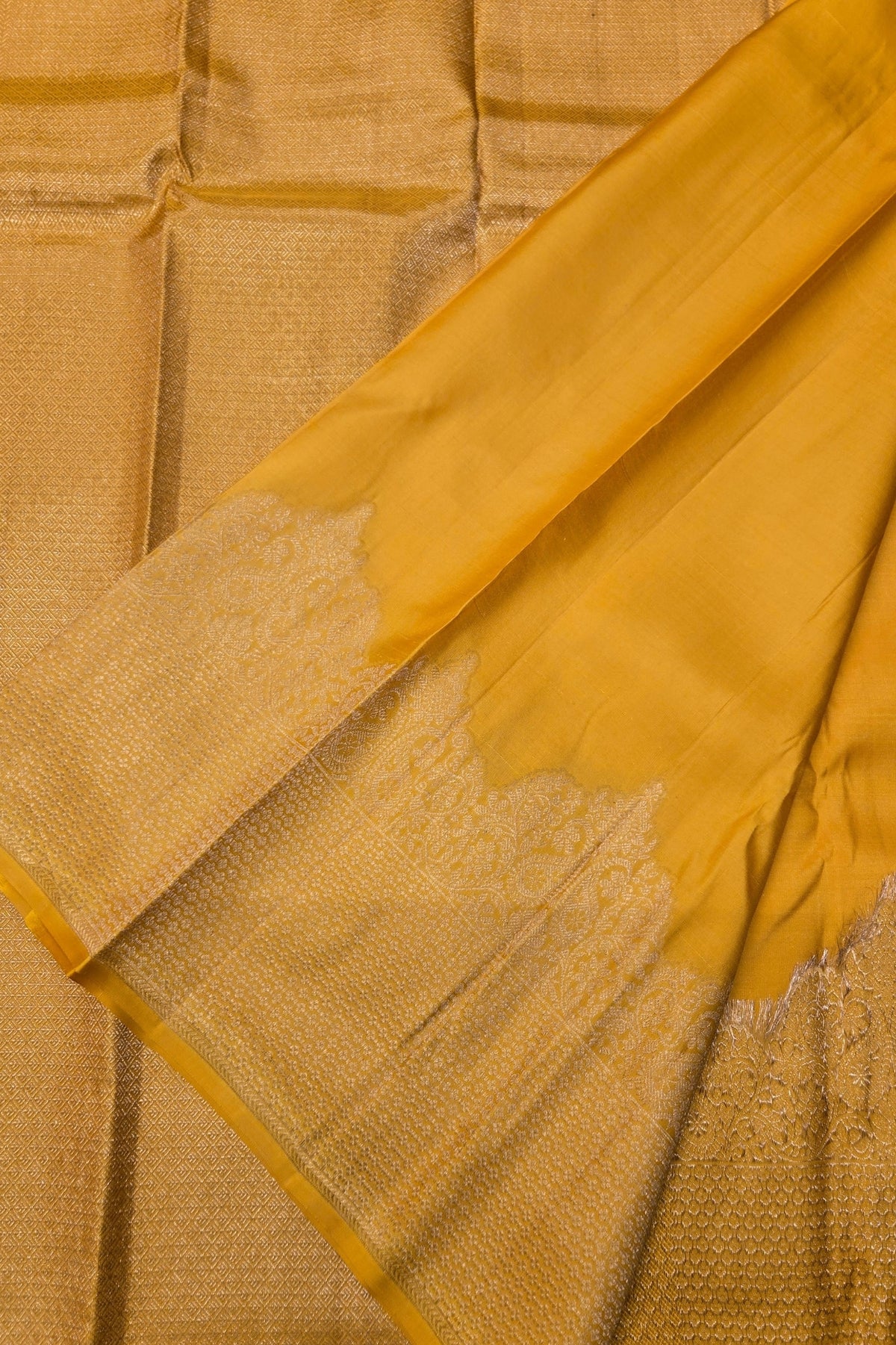 Close-up of a yellow fabric with intricate patterns