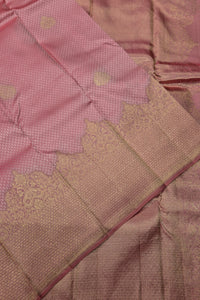 Close-up of a pink fabric with gold embroidery