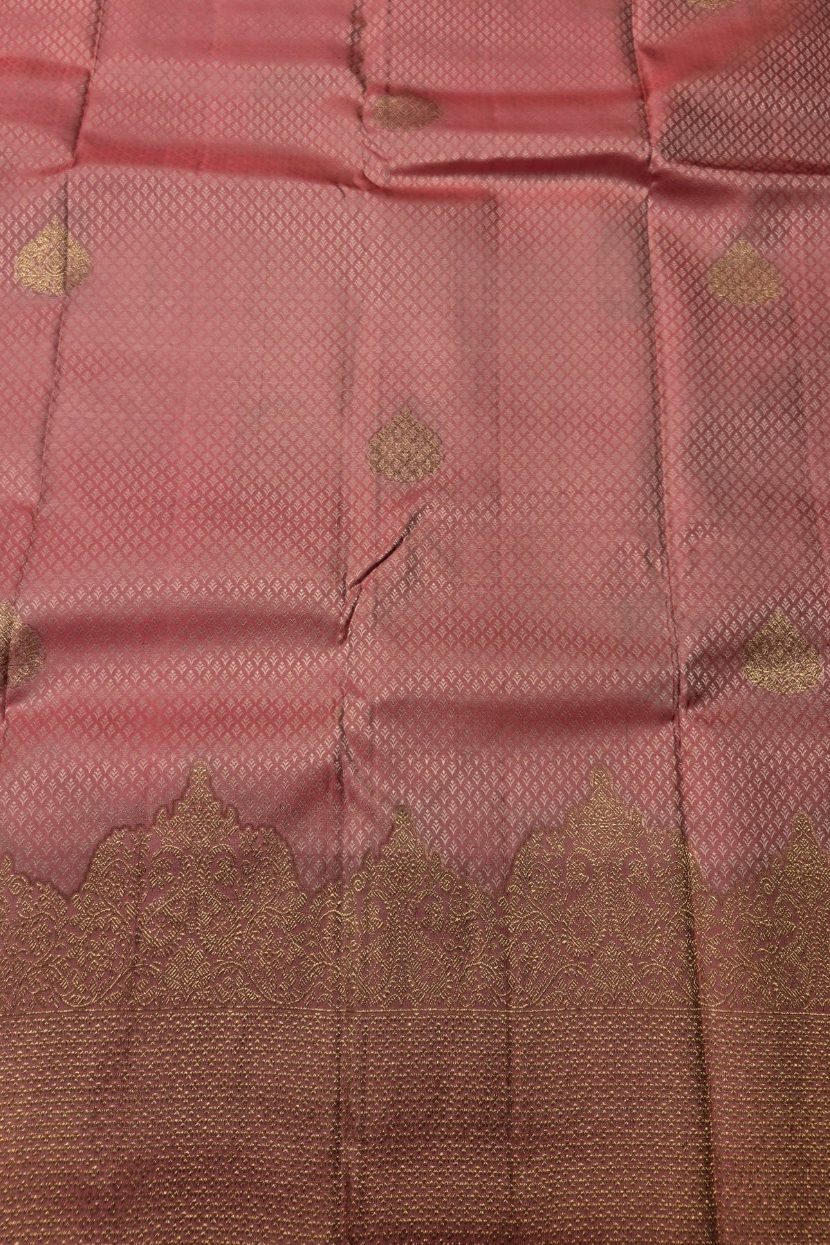 Close-up of pink fabric with gold patterns