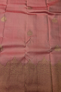 Close-up of pink fabric with gold patterns
