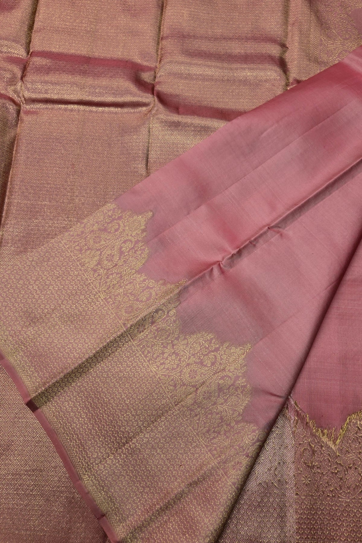 Close-up of a brown and pink saree with intricate patterns