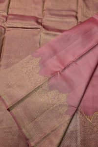 Close-up of a brown and pink saree with intricate patterns