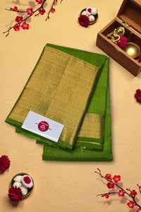 Green fabric with gold border on a beige background with decorative elements
