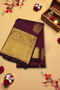 Maroon saree with gold border on a beige background with decorative elements
