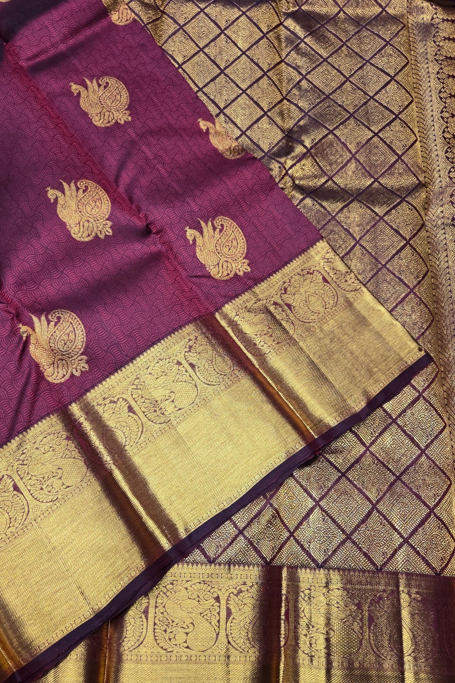 Purple and gold traditional fabric with intricate patterns