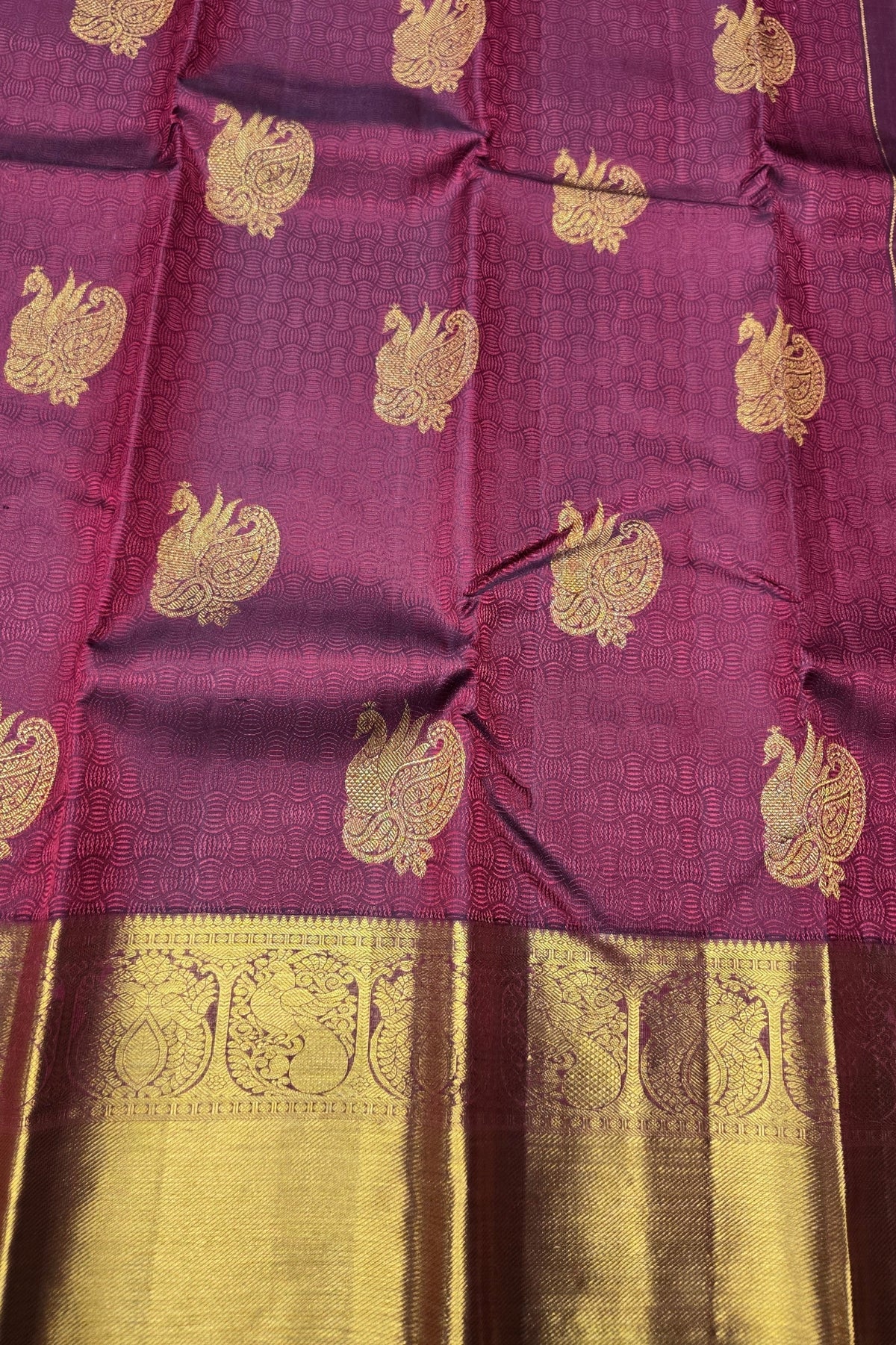 Purple fabric with gold embroidery and border