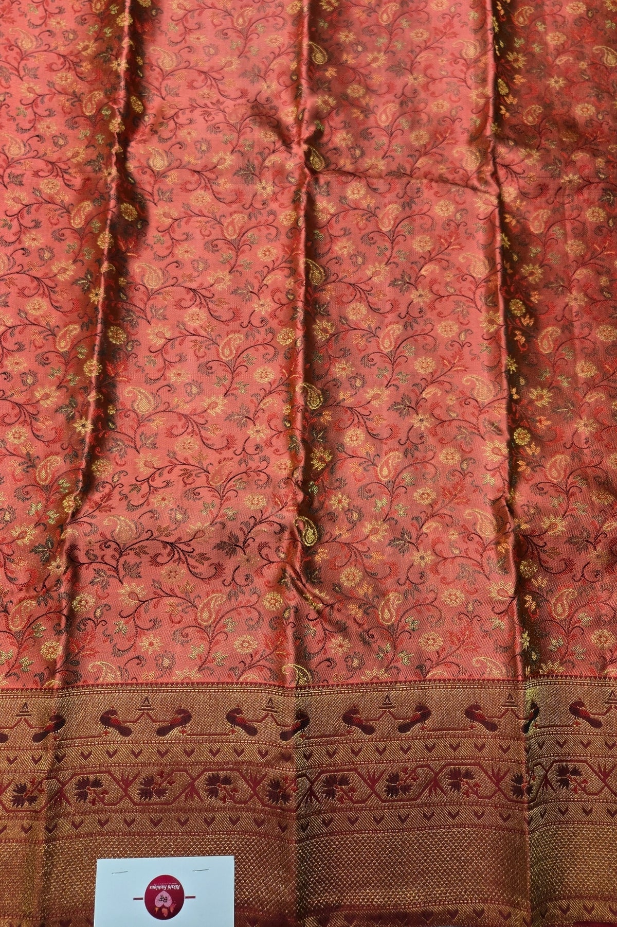 Traditional pink and brown fabric with intricate patterns