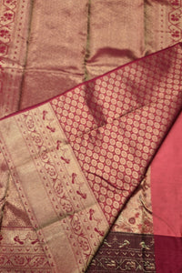 Close-up of a patterned fabric with intricate designs in red and gold.