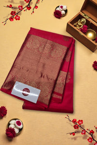 Red saree with gold border on a beige background with decorative elements