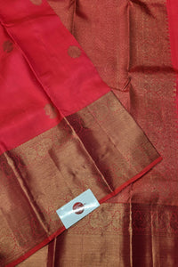 Red and brown fabric with a visible tag