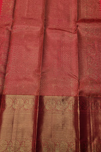 Close-up of a red and gold traditional fabric with intricate patterns