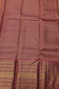 Close-up of a maroon fabric with intricate patterns and a border.