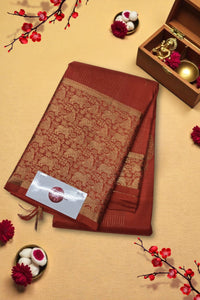 Red saree with gold border on a beige background with decorative elements