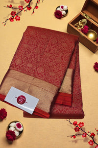Red and beige folded fabric with a card on a decorative background