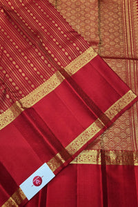 Red fabric with gold border and pattern, featuring a brand logo at the bottom.