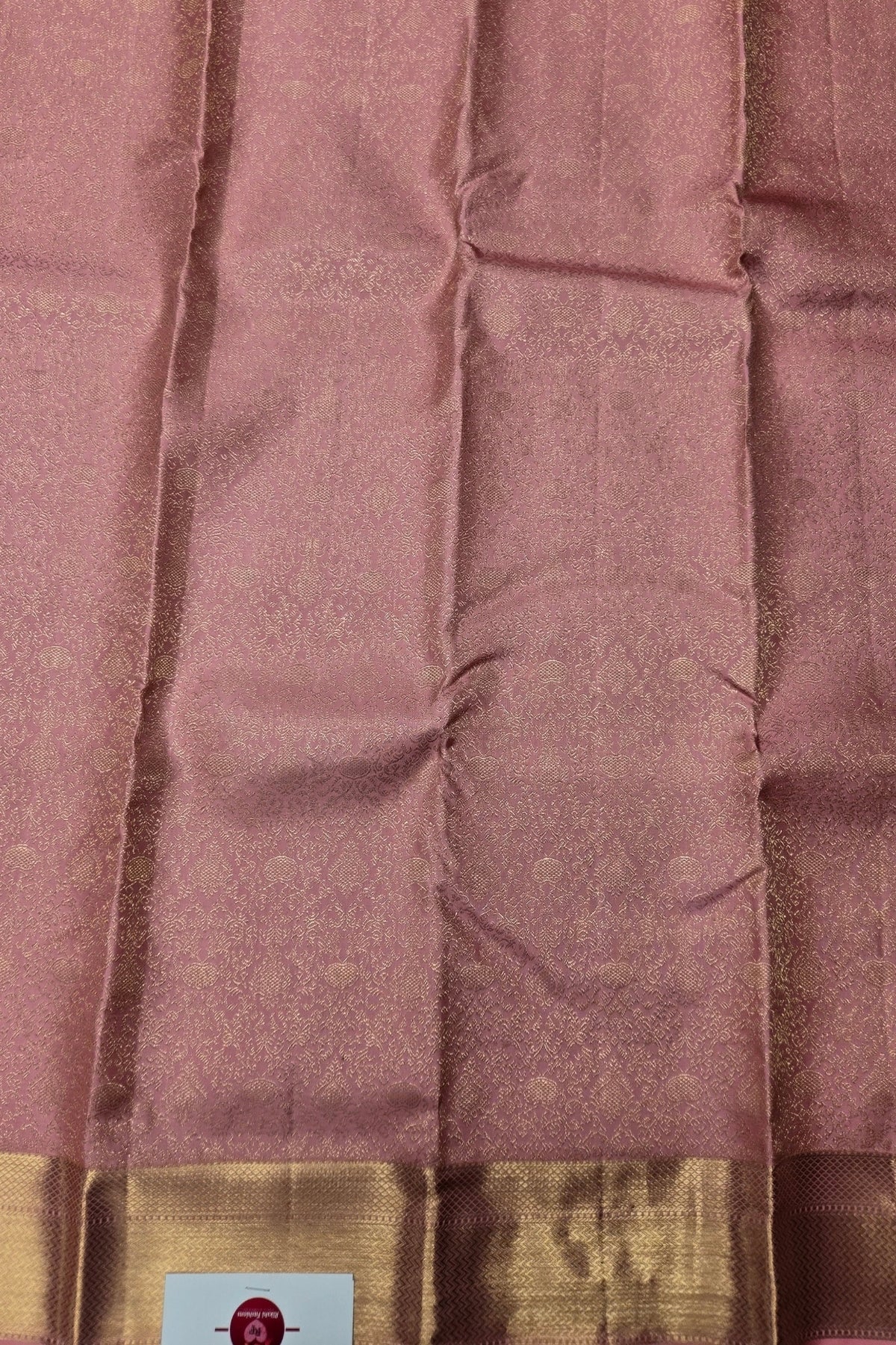 Close-up of a maroon fabric with a gold border