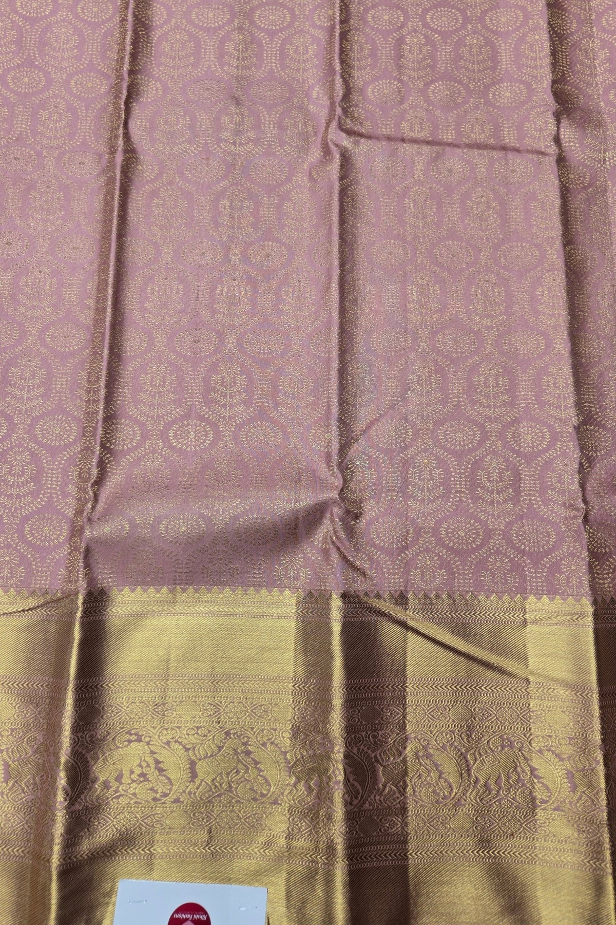Silk saree with a pink and gold patterned design
