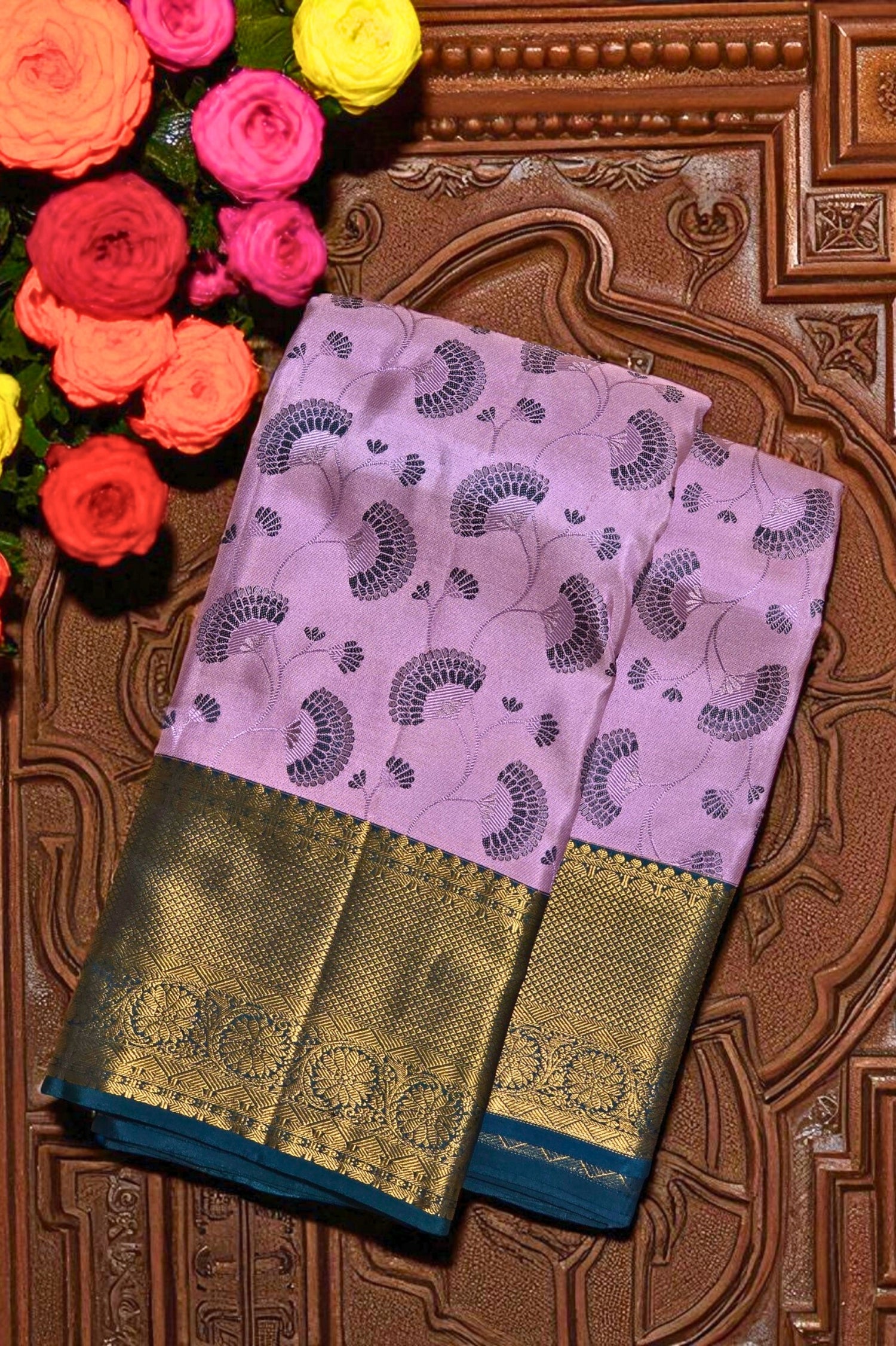 Pink saree with gold border on a decorative background