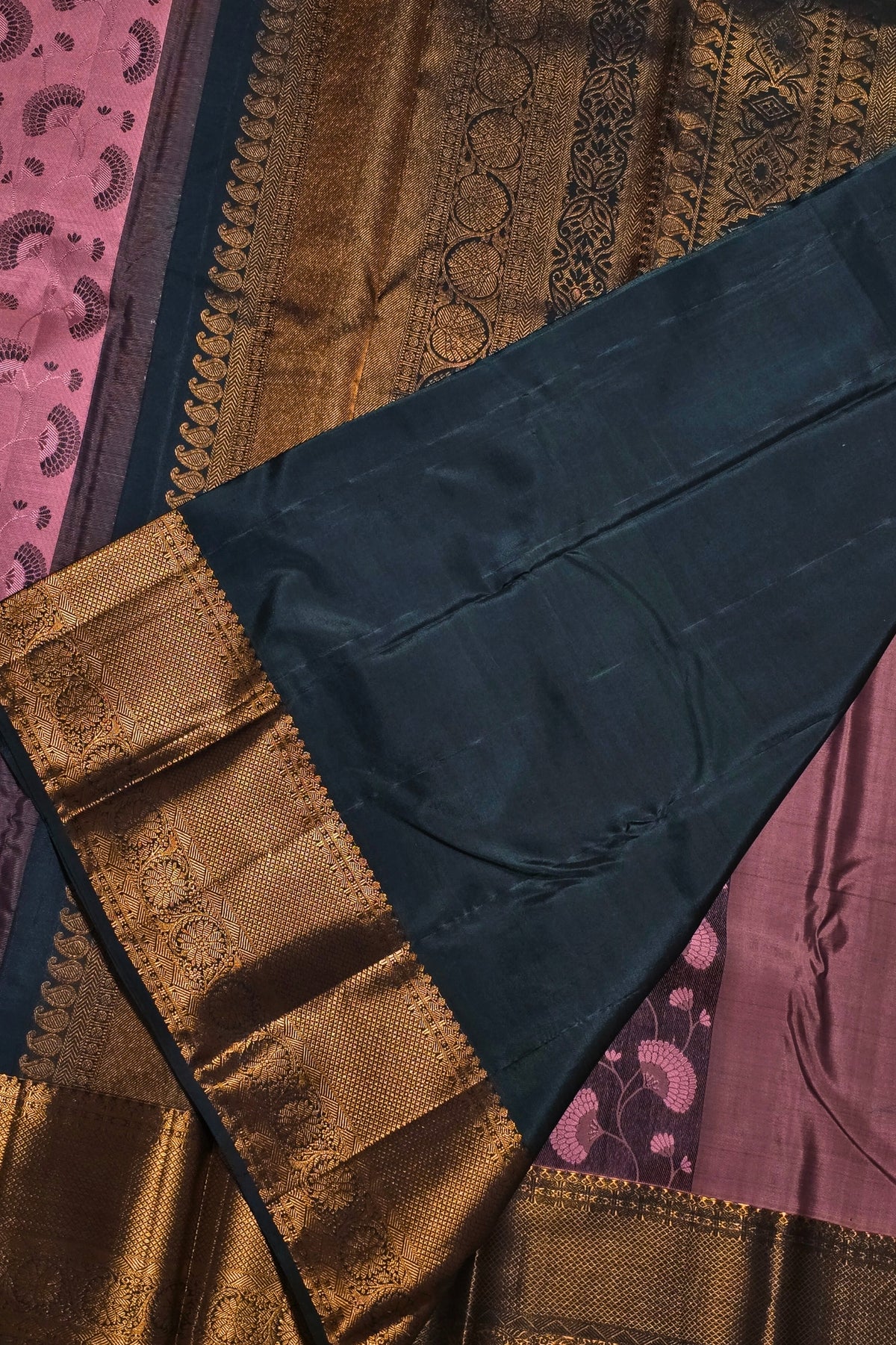 Close-up of a patterned fabric with gold, brown, and blue colors.