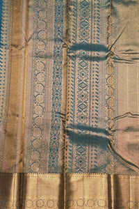 Close-up of a patterned fabric with gold and blue tones