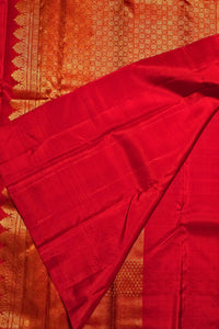 Red fabric with intricate patterns on a textured background