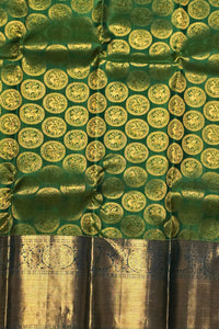 Green fabric with gold circular patterns and a brown border