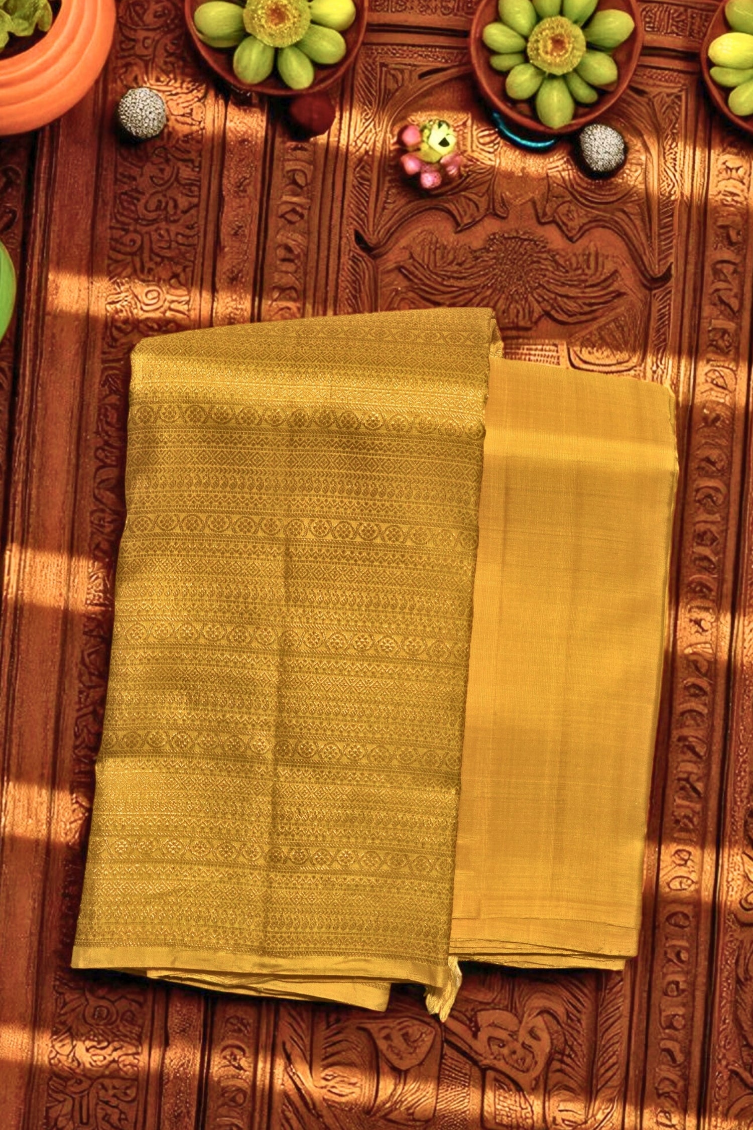 Yellow fabric on a wooden surface with decorative items.