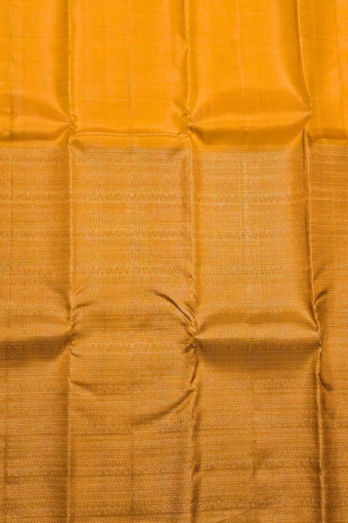 Close-up of a mustard yellow fabric with a subtle pattern