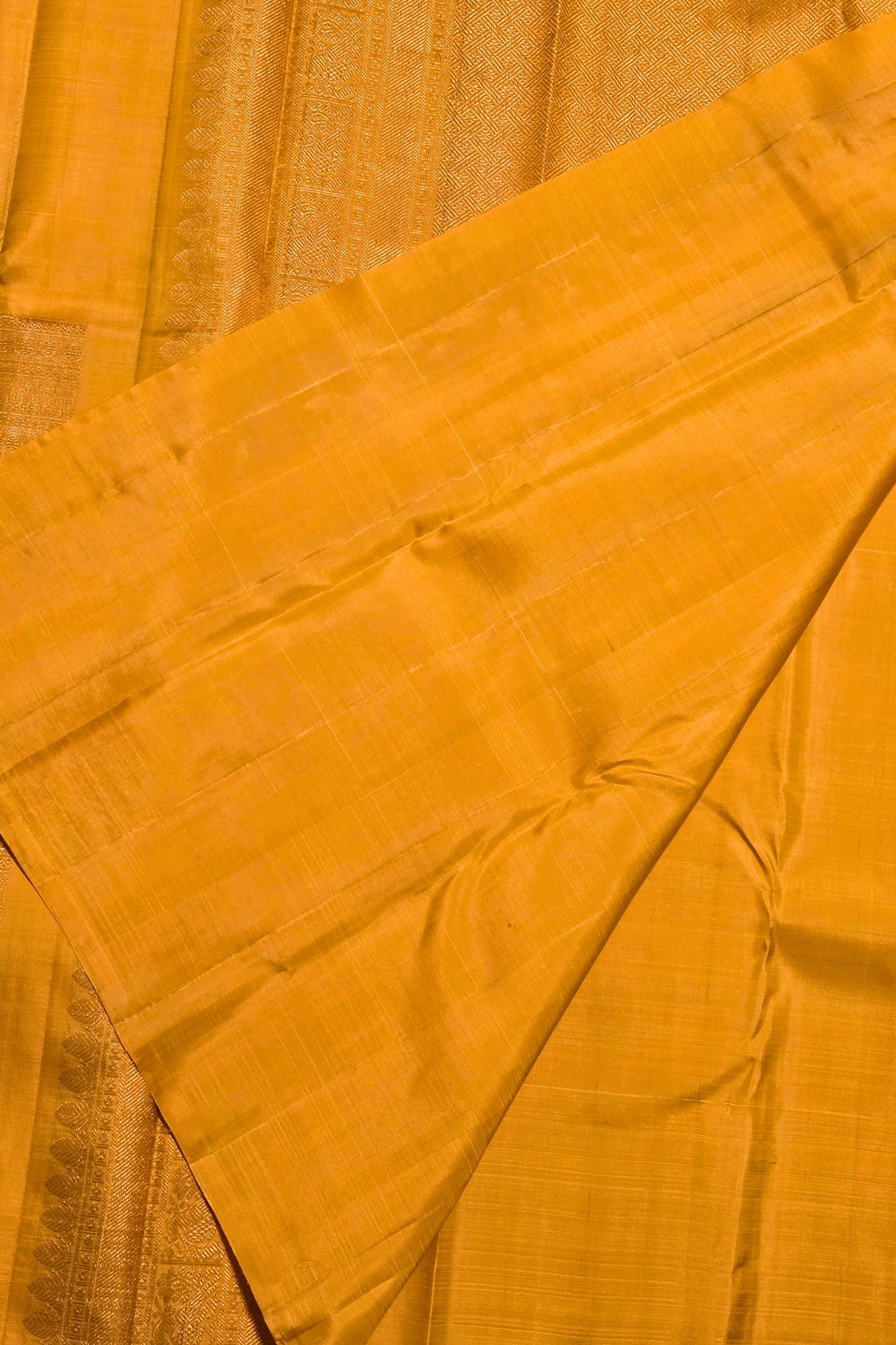 Close-up of a yellow fabric with a subtle pattern