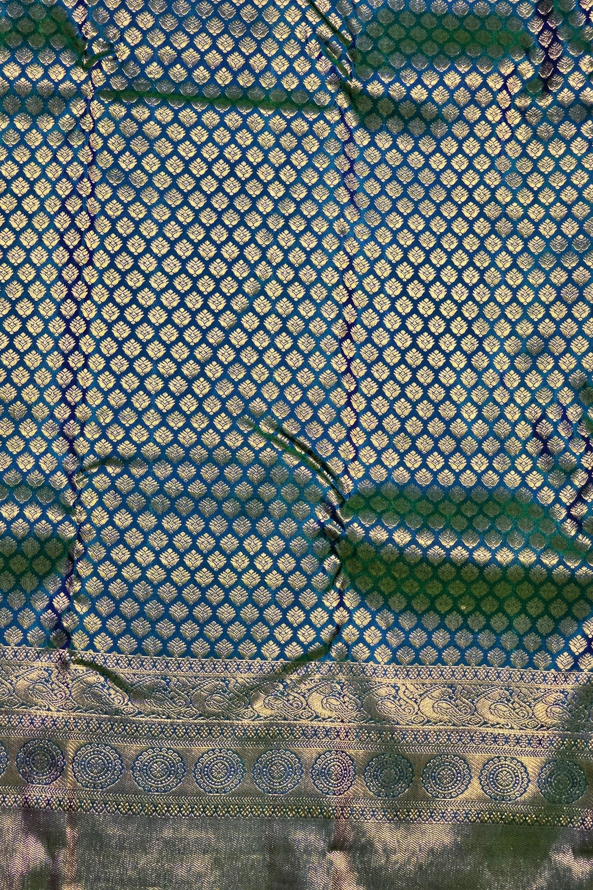 Close-up of a blue fabric with gold geometric pattern